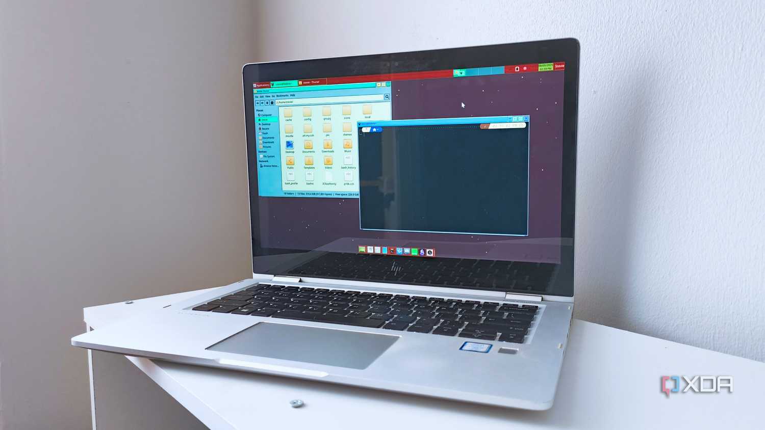 A 2017 HP EliteBook x360 1030 G2 running Fedora 42 with the XFCE desktop environment and a retro panel theme
