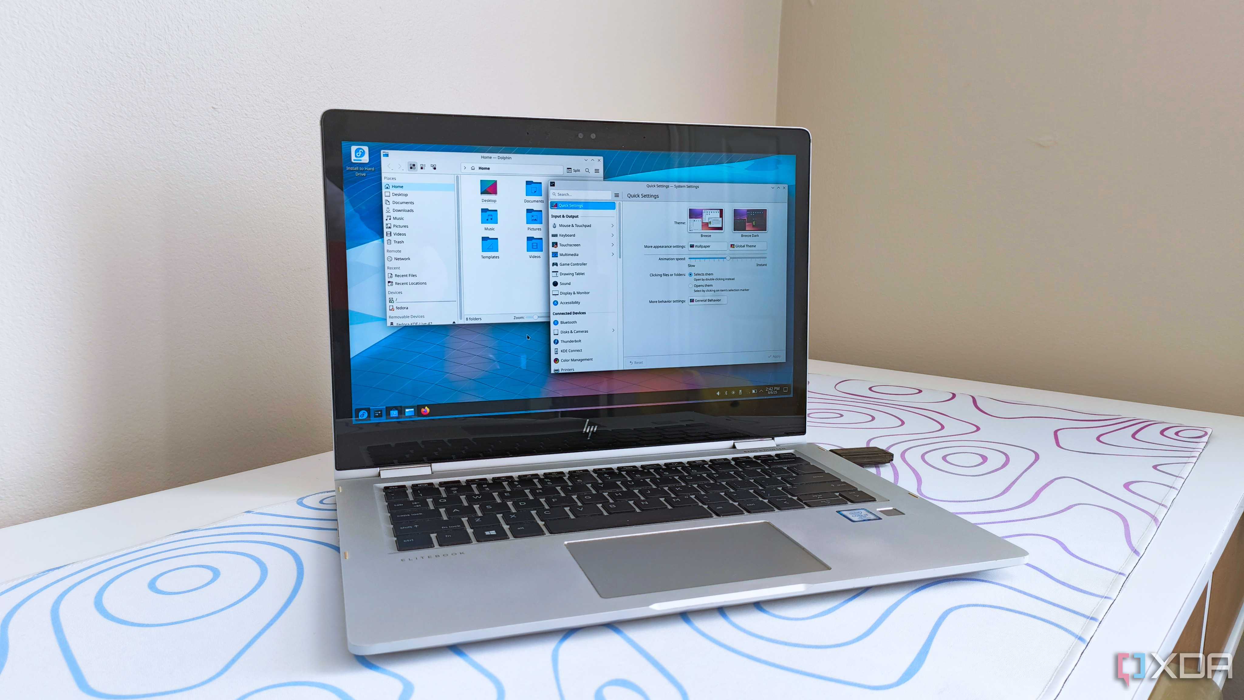 photo of a 2017 HP Elitebook x360 1030 G2 running Fedora Linux with the KDE desktop environment
