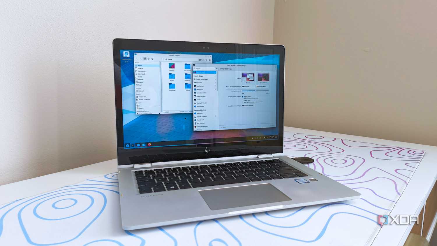 photo of a 2017 HP Elitebook x360 1030 G2 running Fedora Linux with the KDE desktop environment