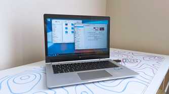 photo of a 2017 HP Elitebook x360 1030 G2 running Fedora Linux with the KDE desktop environment