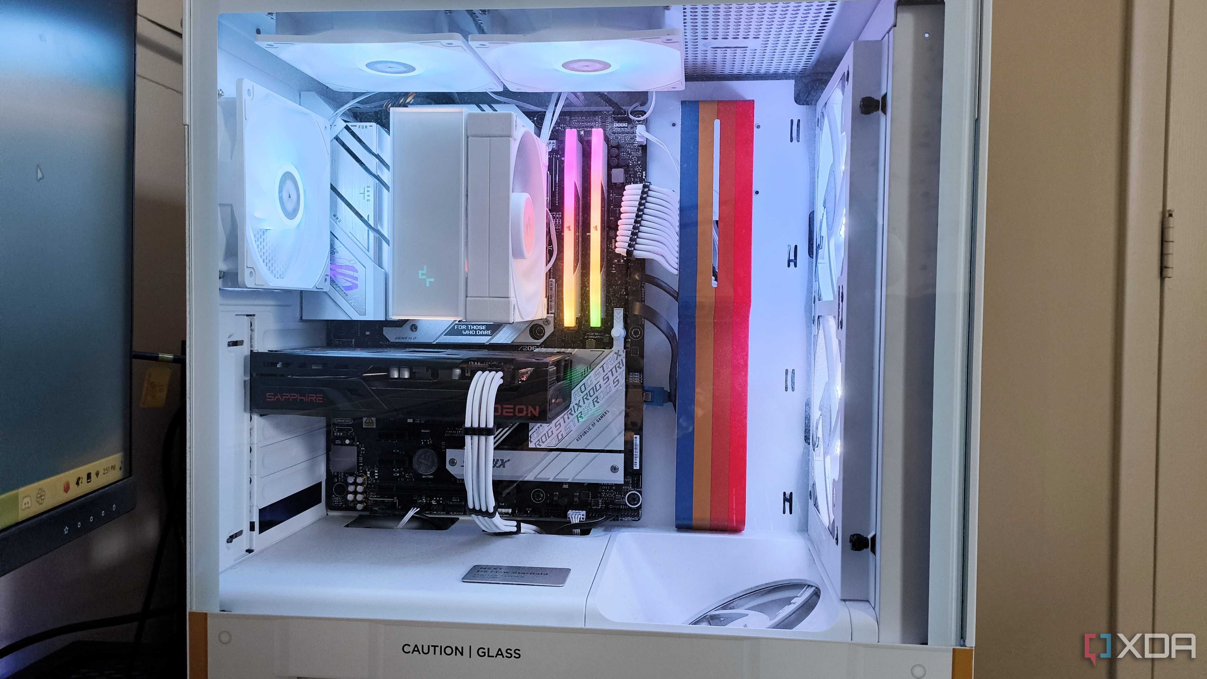 An NZXT H5 Flow Starfield gaming PC case with complete backlit build inside seen from the side