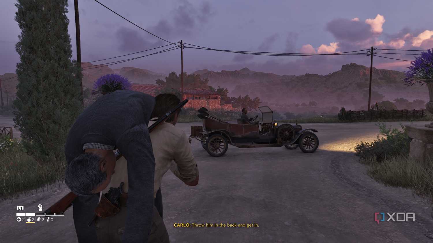 Carrying a man towards a car in Mafia: The Old Country.
