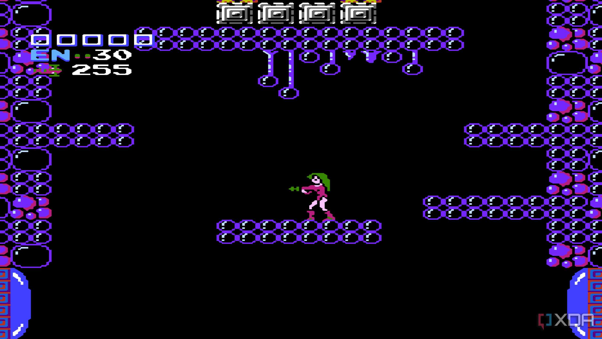 A screenshot from Metroid on the NES, showing Samus in a pink bodysuit.