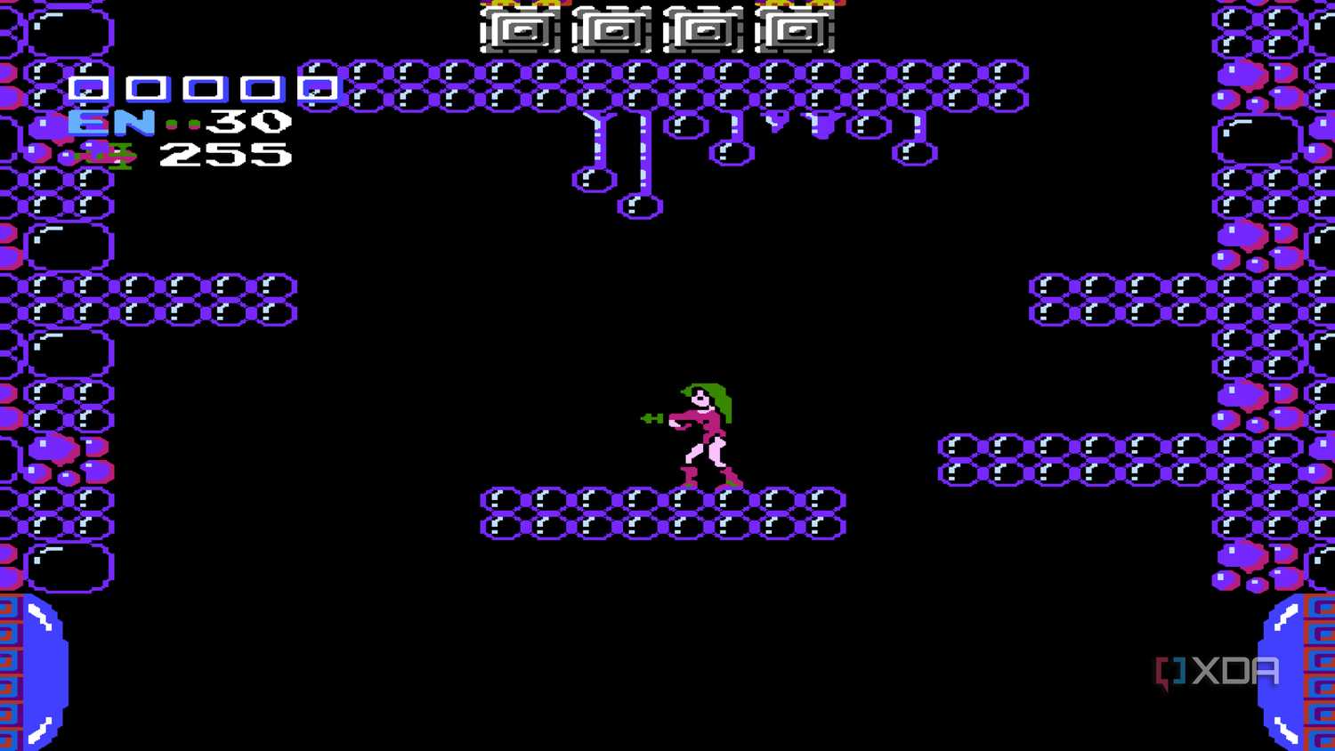 A screenshot from Metroid on the NES, showing Samus in a pink bodysuit.