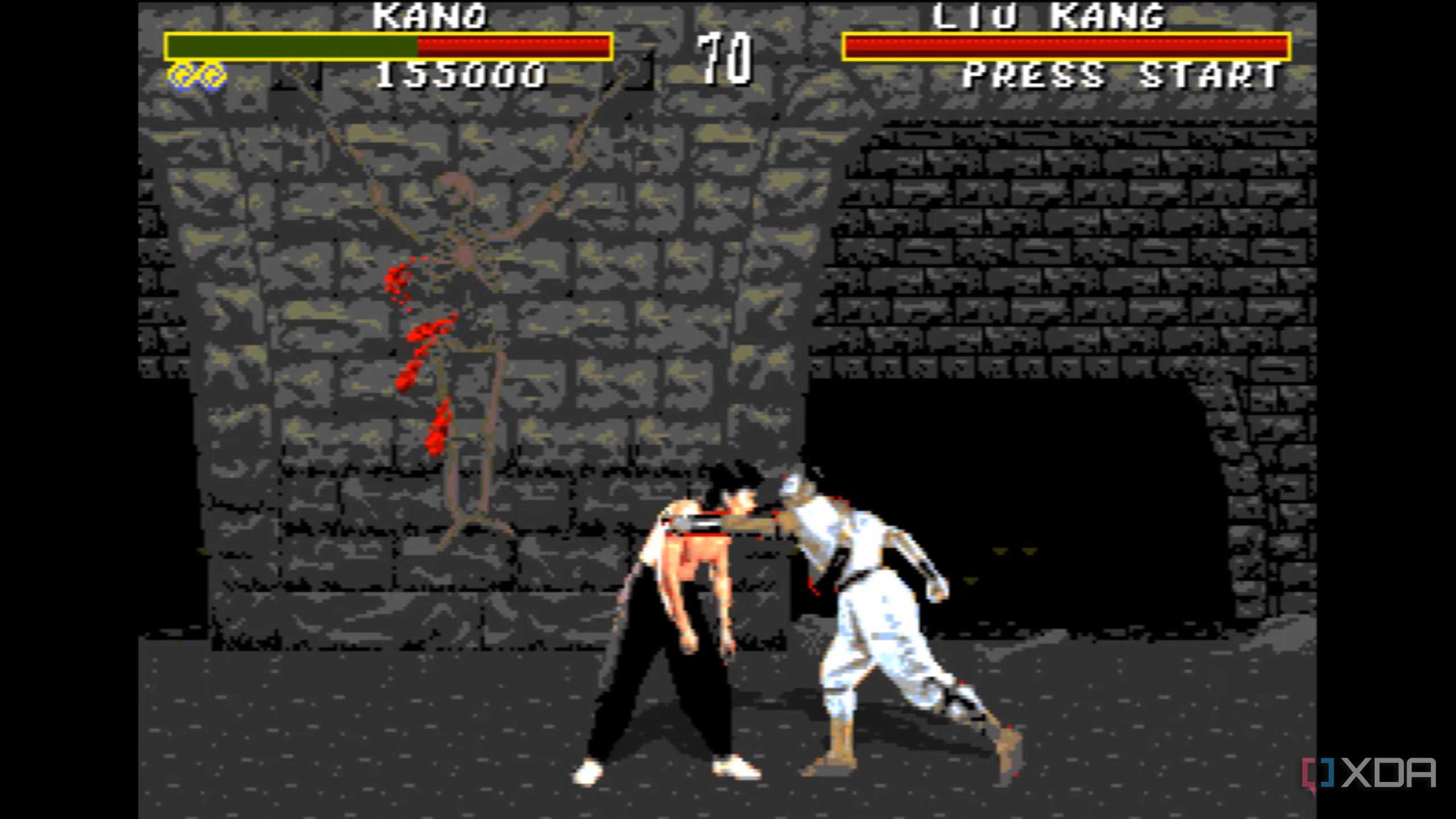 Liu Kang hitting Kano to draw blood in Mortal Kombat on the Sega Genesis.