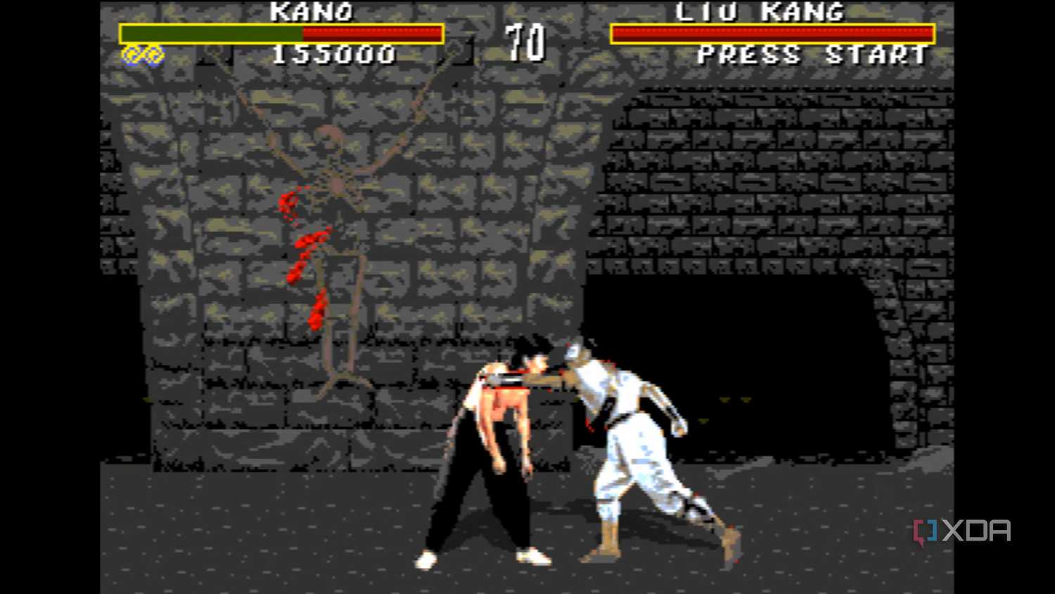 Liu Kang hitting Kano to draw blood in Mortal Kombat on the Sega Genesis.