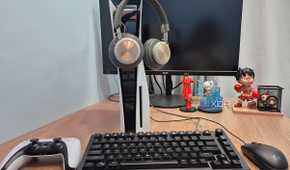 Headphones hanging on a PlayStation 5 console.