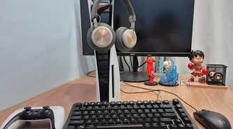 Headphones hanging on a PlayStation 5 console.