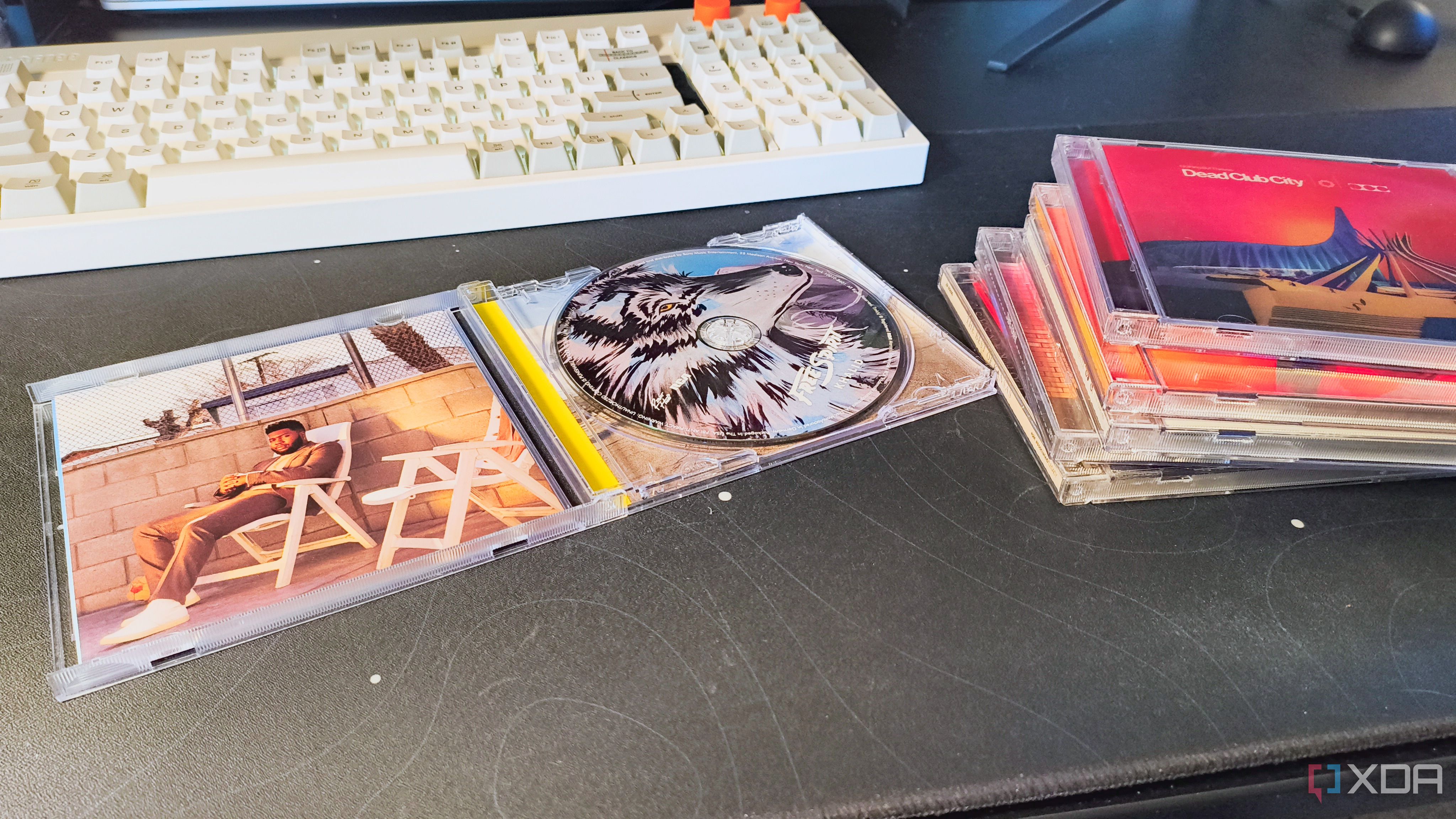 Khalid's "Free Spirit" CD open on a desk next to a keyboard and a stack of CDs