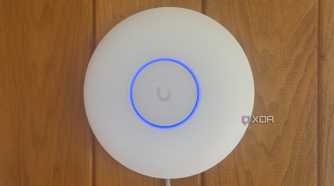 Ubiquiti access point mounted to a wood panel wall in an old college dorm