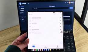 vikunja app on a foldable phone with a laptop in the background