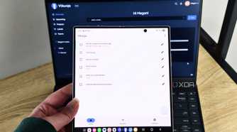 vikunja app on a foldable phone with a laptop in the background