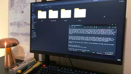 Windows Explorer file system and Windows Notepad with text displayed on a desktop, LEGO and lamp in view