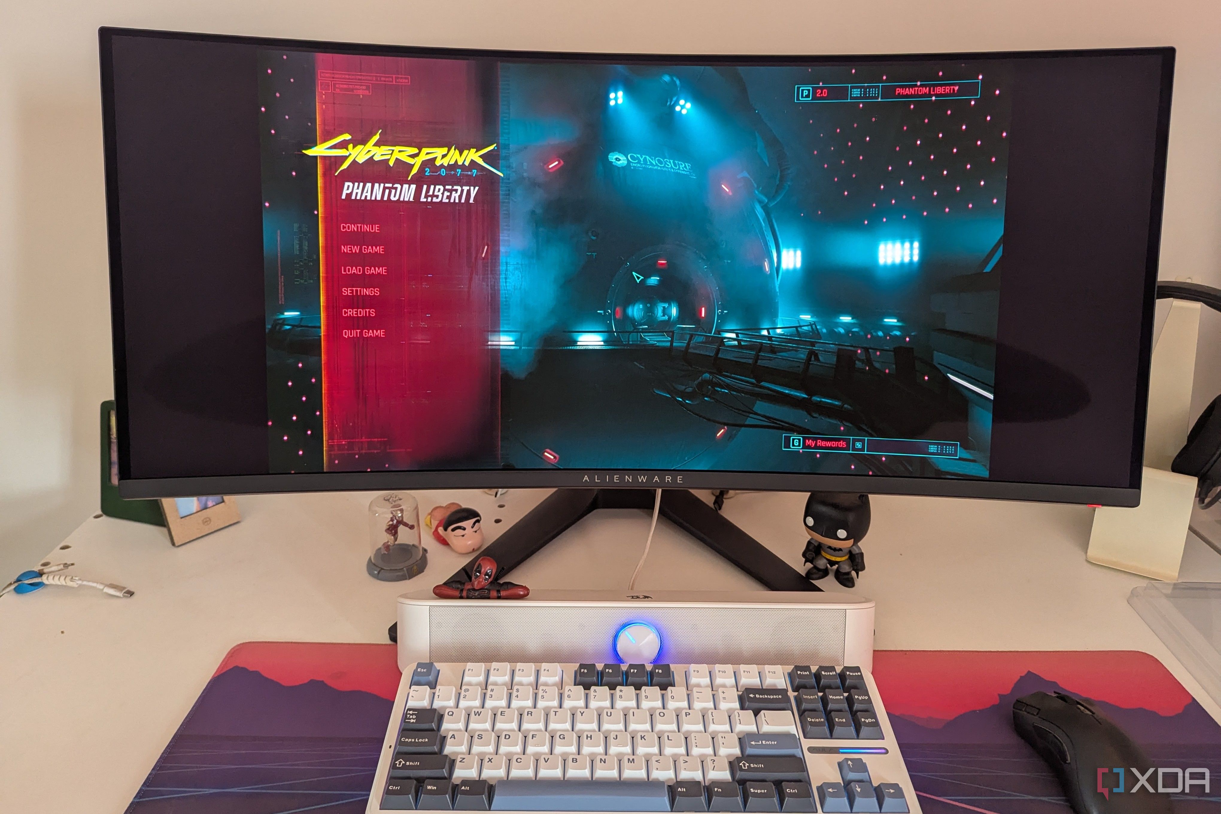 An ultrawide monitor showing the main menu of Cyberpunk 2077