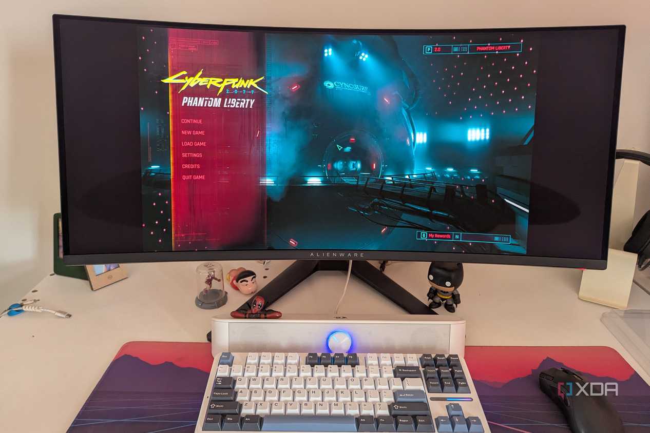 An ultrawide monitor showing the main menu of Cyberpunk 2077