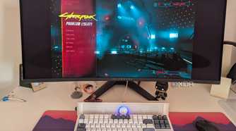 An ultrawide monitor showing the main menu of Cyberpunk 2077