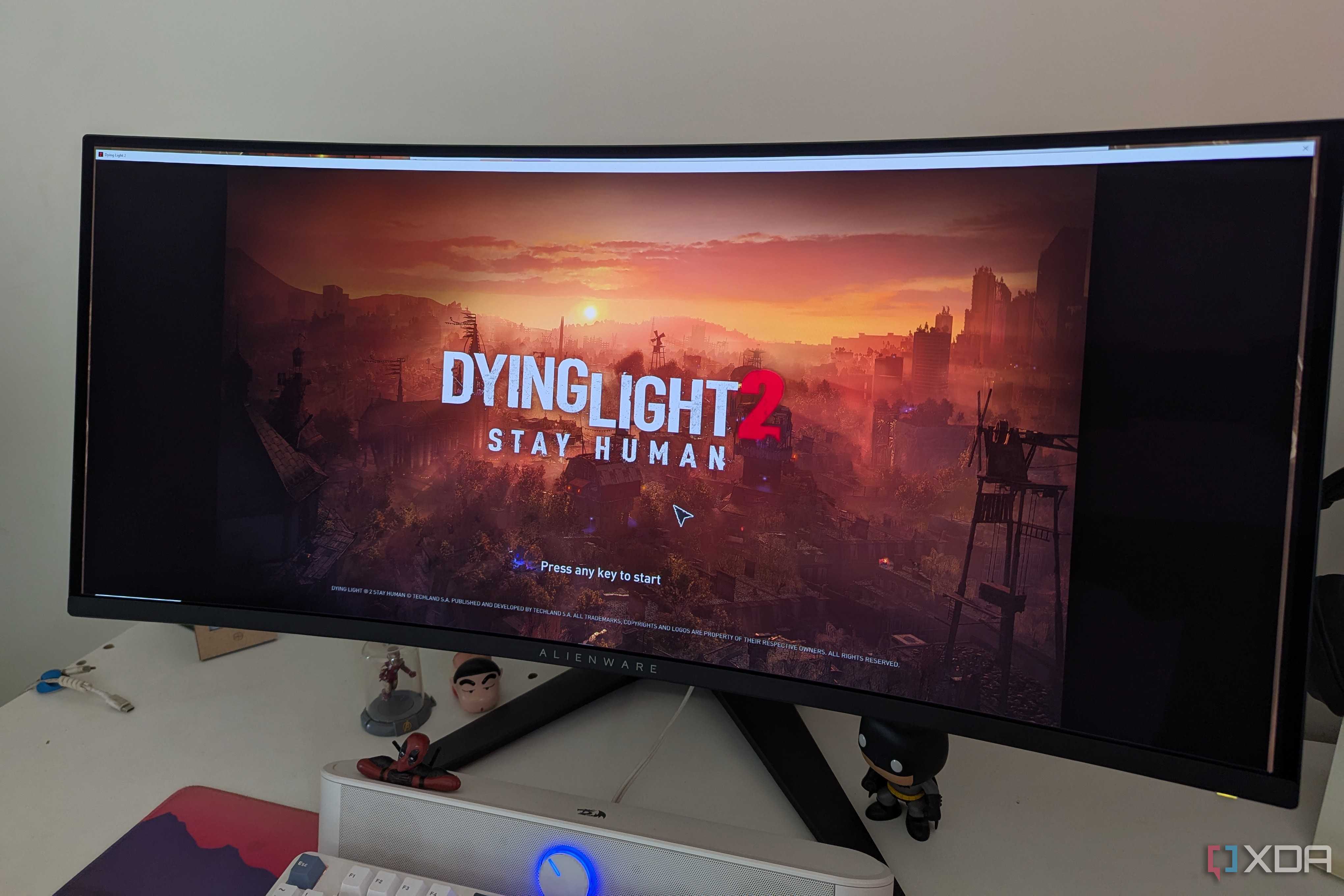 An ultrawide monitor showing the main menu of Dying Light 2