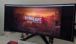 An ultrawide monitor showing the main menu of Dying Light 2
