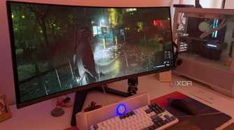 An ultrawide OLED monitor playing Alan Wake 2