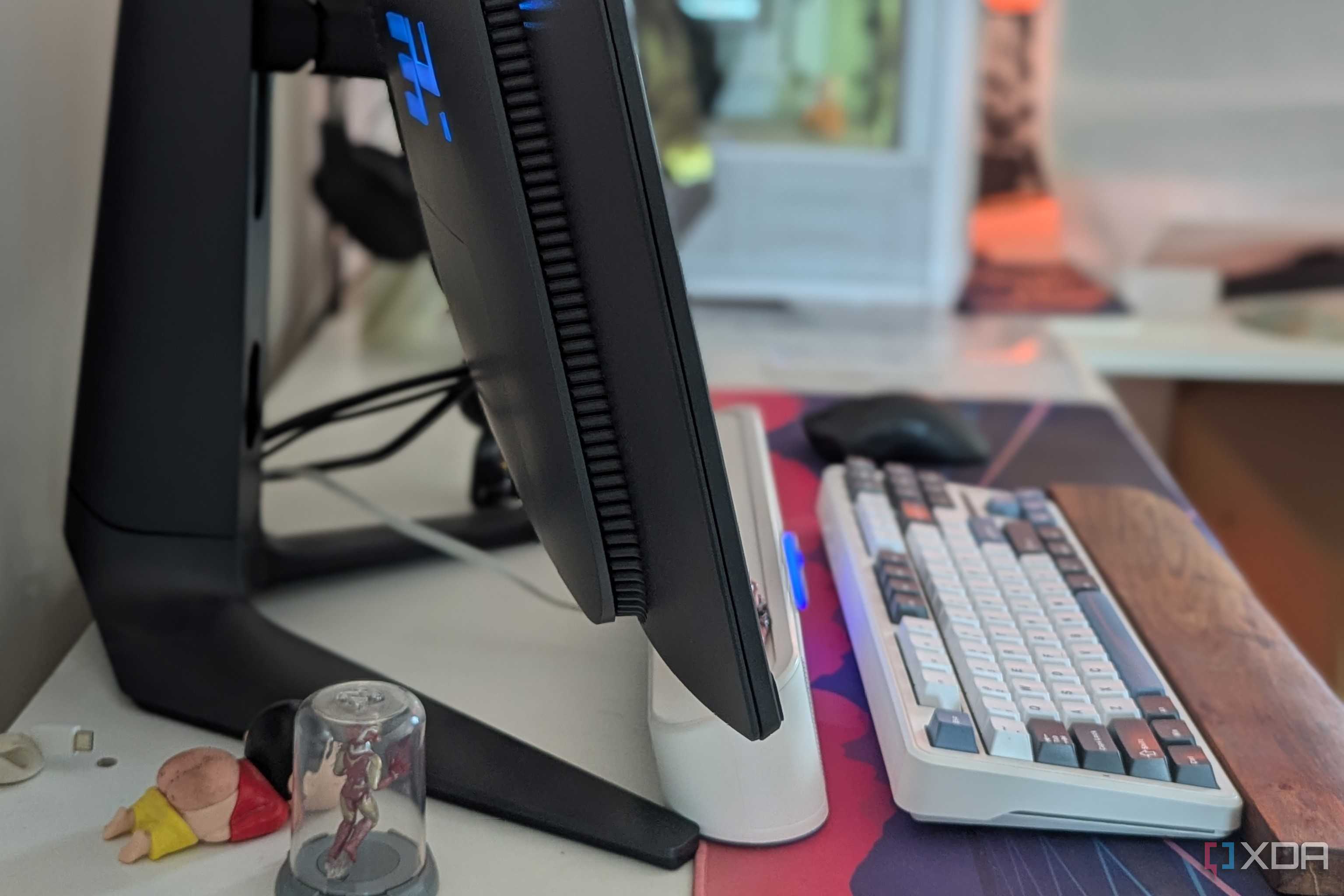 Side view of a curved monitor on a desk next to a keyboard