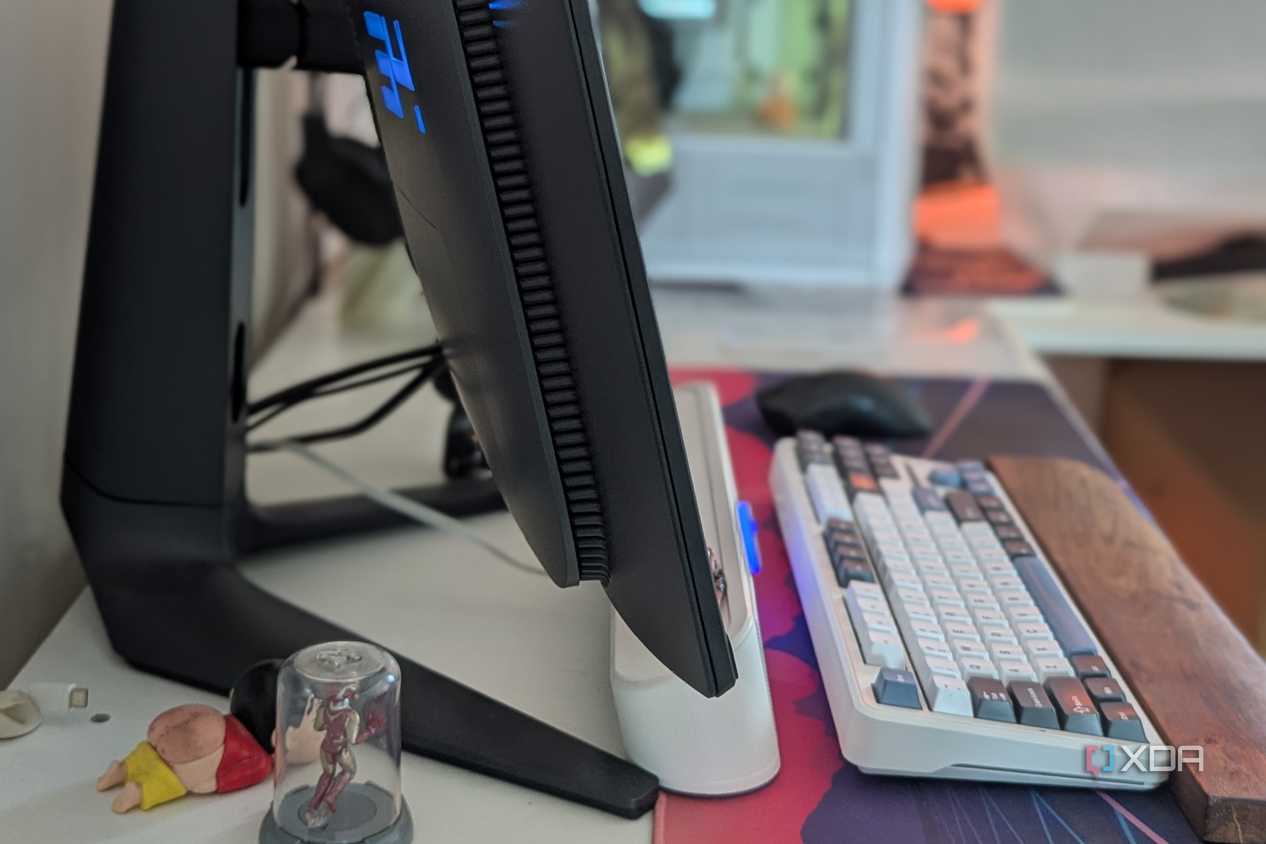 Side view of a curved monitor on a desk next to a keyboard