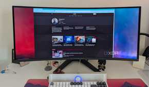 A browser window on an ultrawide OLED monitor next to a keyboard on a desk