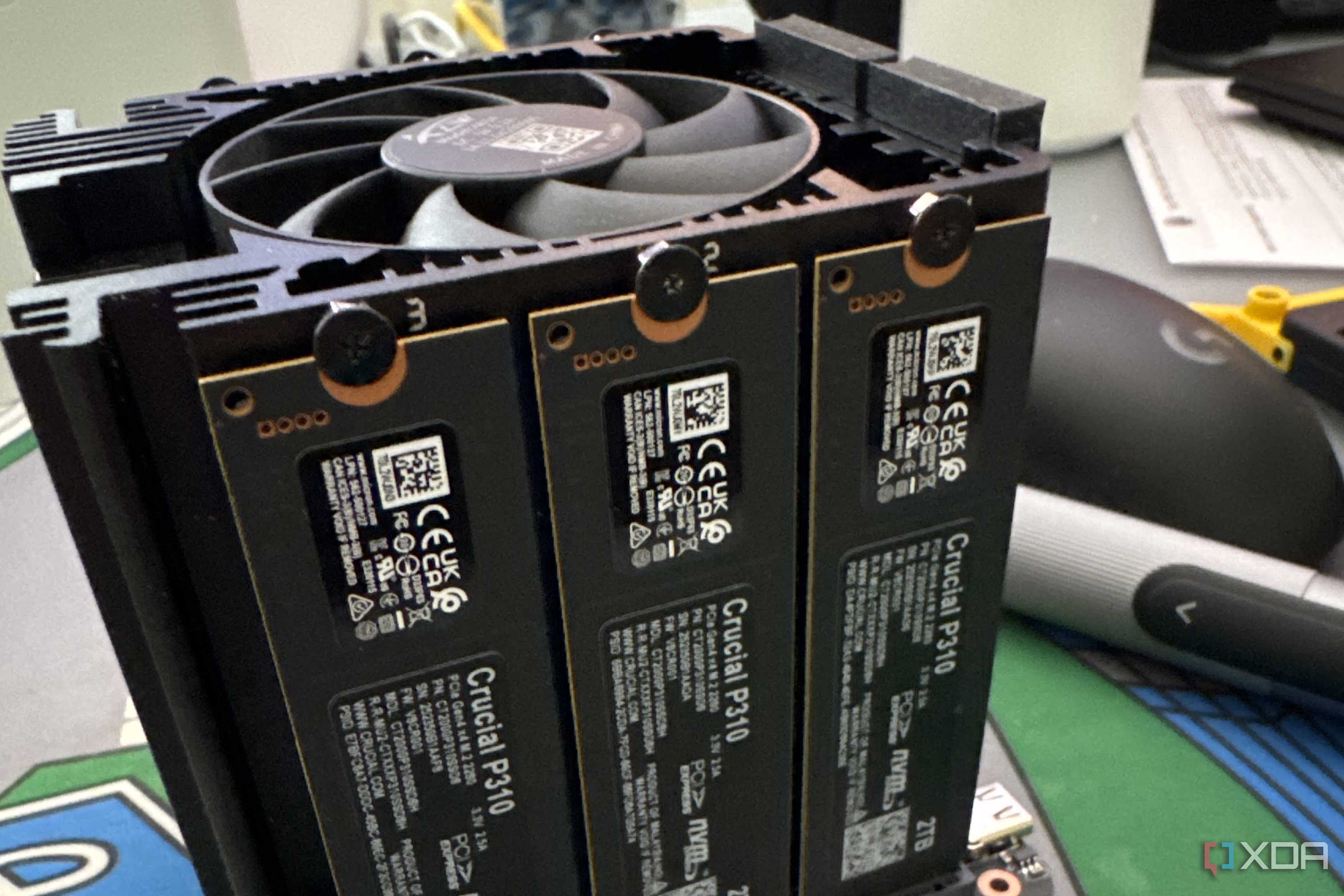 beelink mini pc with top cover off showing three crucial nvme ssds installed