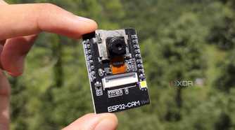 A person holding the ESP32 CAM board