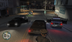 Driving past a police vehicle in GTA IV.