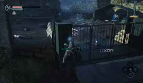 A locked gate with a camp behind it in Hell is Us.