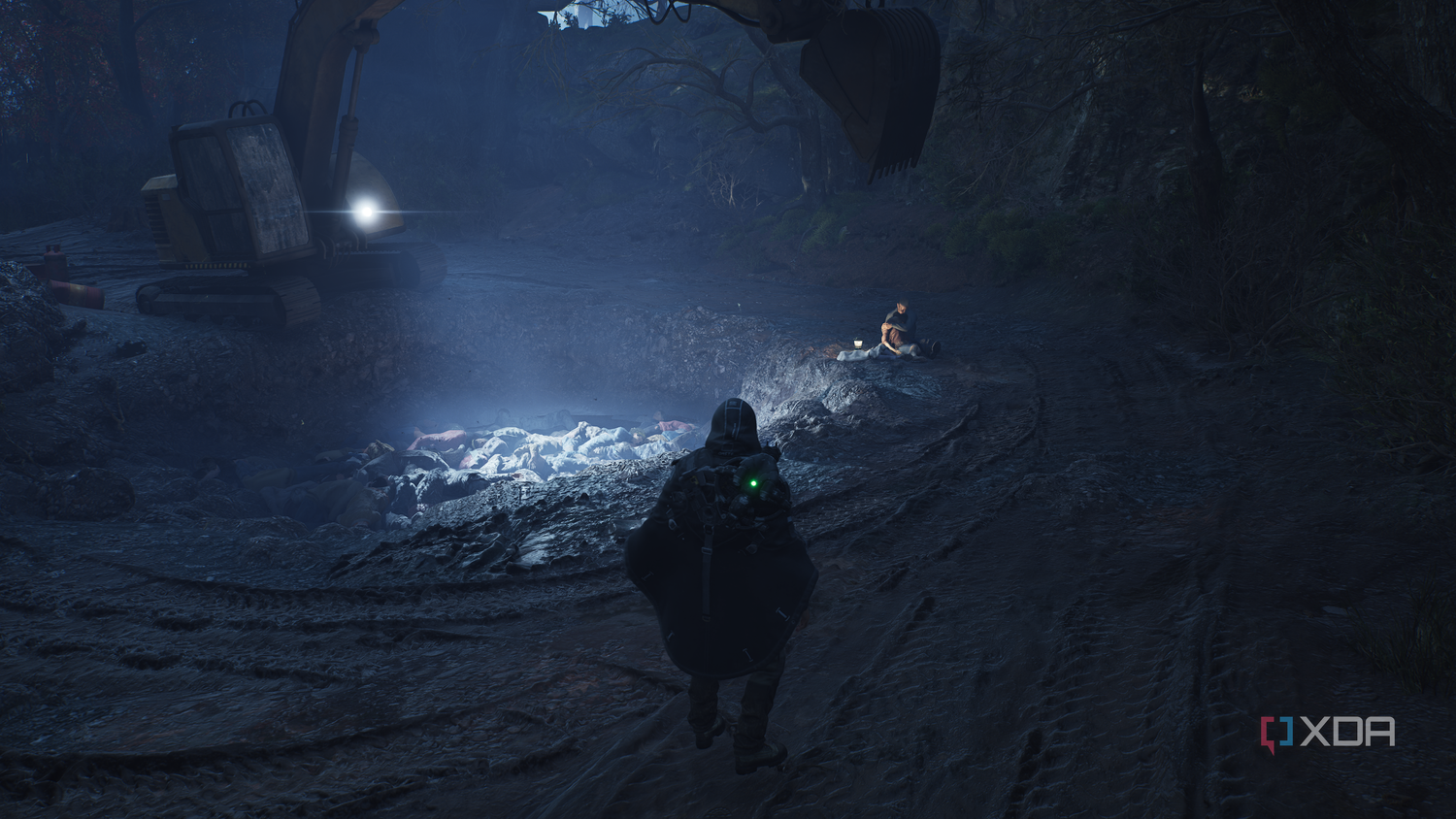 A man kneeling next to a pit of corpses in Hell is Us.