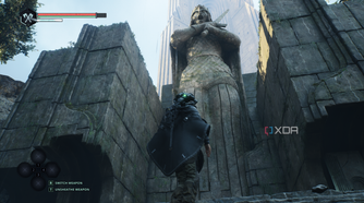 Remi standing next to a gigantic statue in Hell is Us.