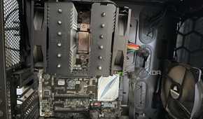 A photo of the inside of a PC, showing a CPU cooler with the fans attached incorrectly