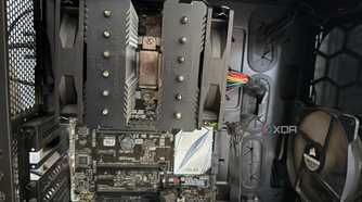 A photo of the inside of a PC, showing a CPU cooler with the fans attached incorrectly
