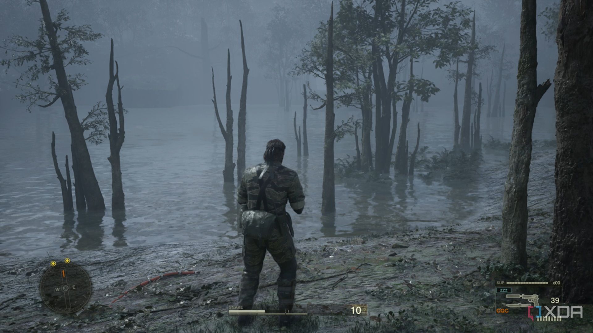 A screenshot of Snake going into a swamp area in Metal Gear Solid Delta: Snake Eater