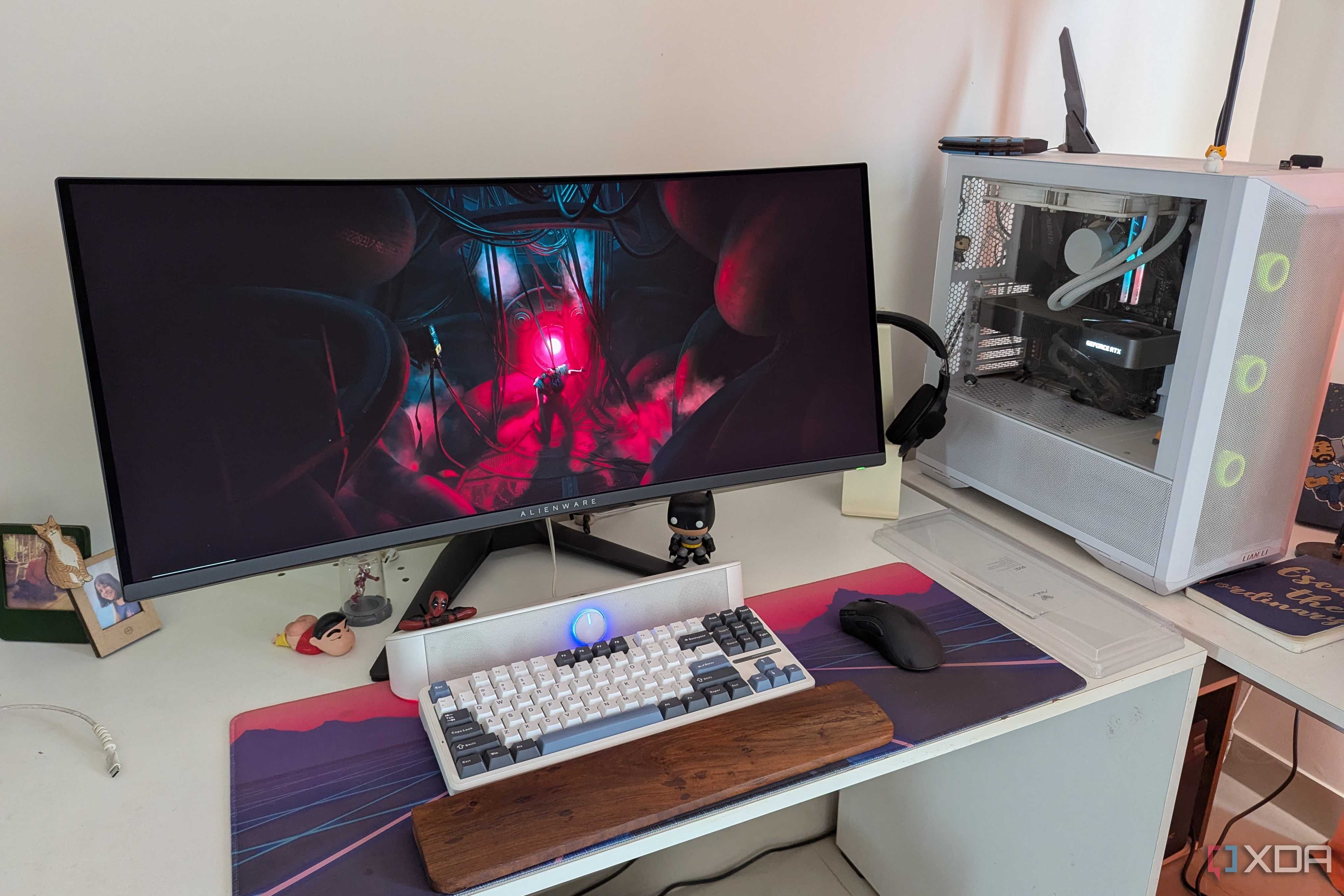 A PC setup showing a white PC and curved monitor on a white desk