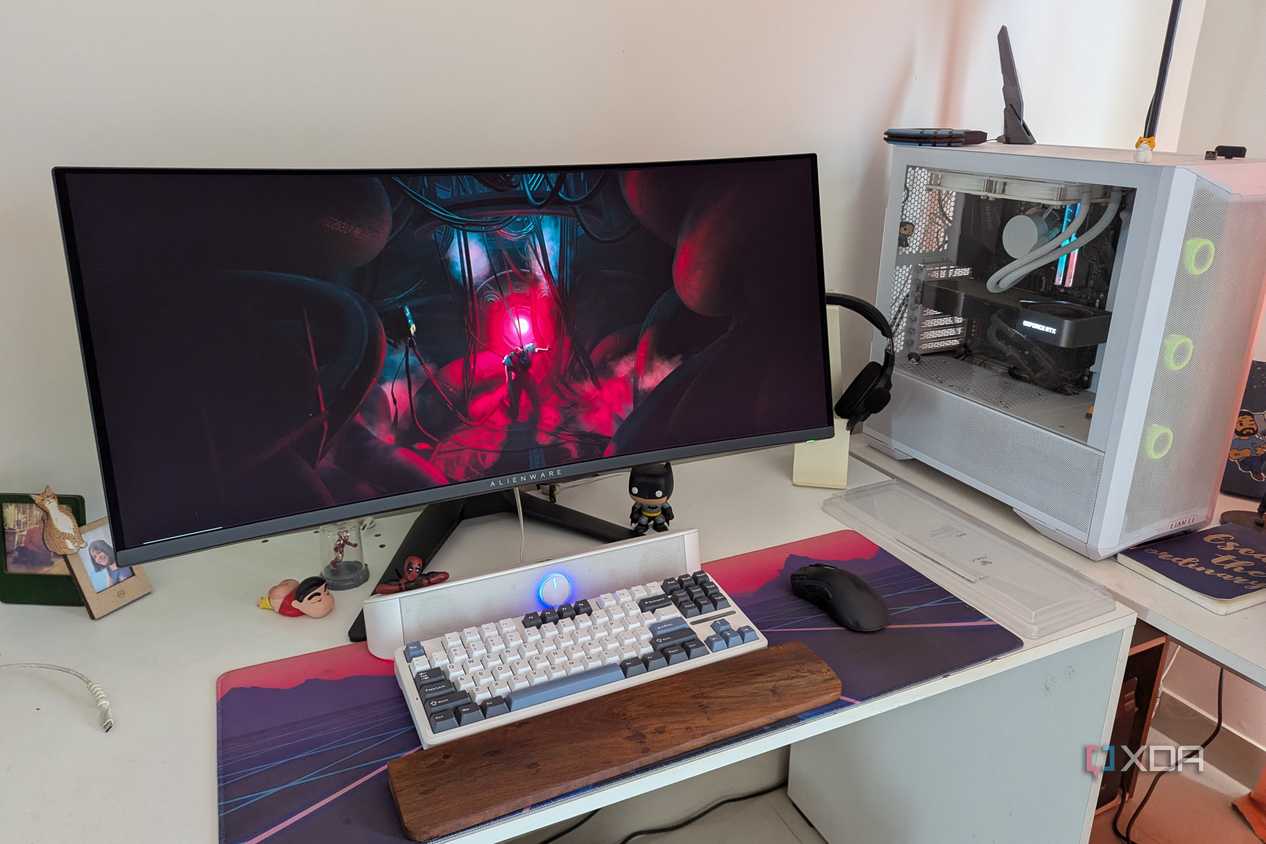 A PC setup showing a white PC and curved monitor on a white desk