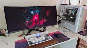 A PC setup showing a white PC and curved monitor on a white desk