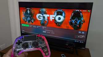 An RGB controller next to a TV running Steam Link