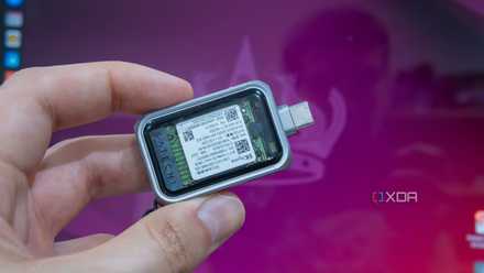 A portable USB SSD drive in front of the screen of a computer running Ubuntu