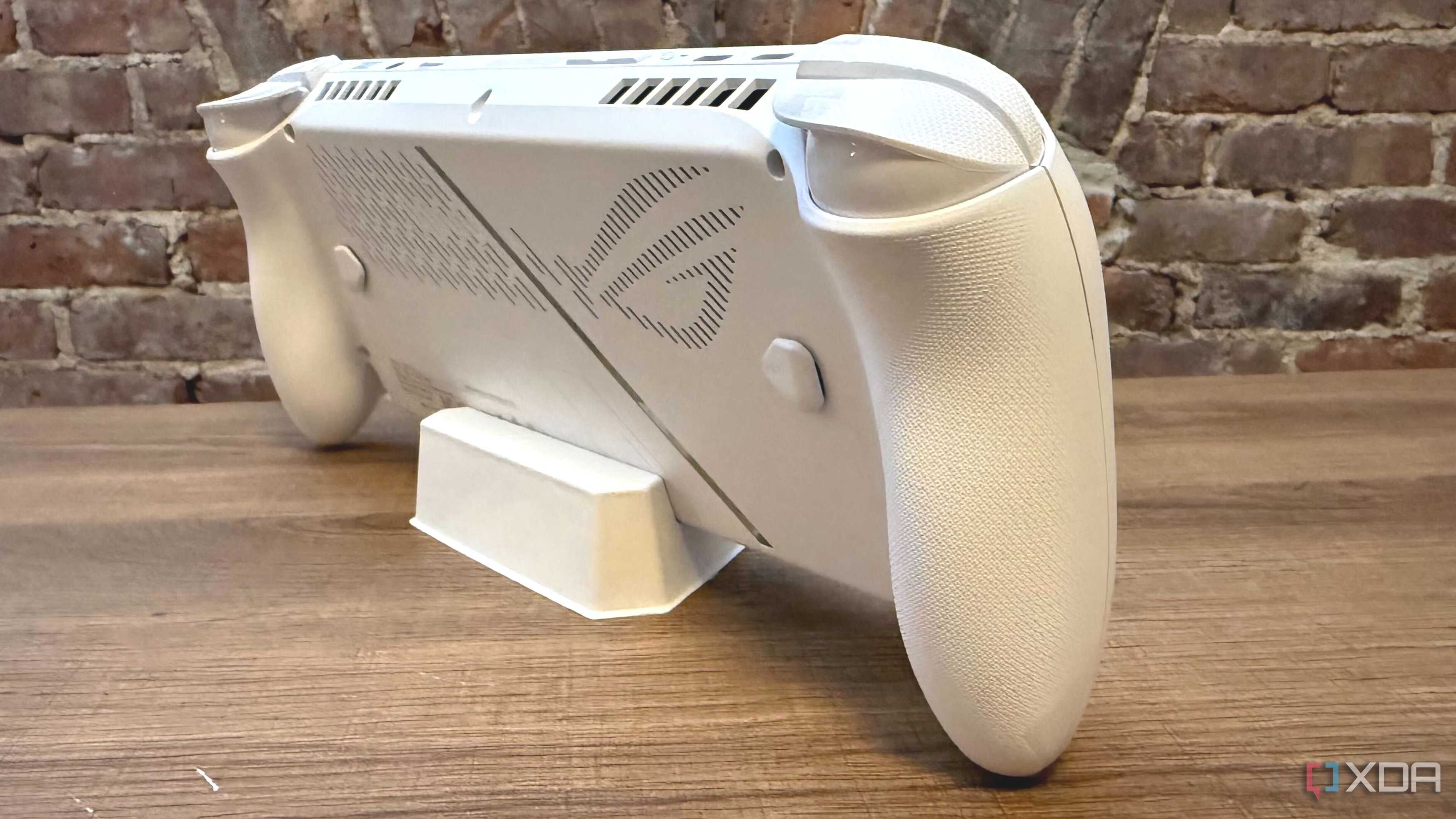 Angled view of the Asus ROG Ally, focusing on the ROG detailing on the back side.