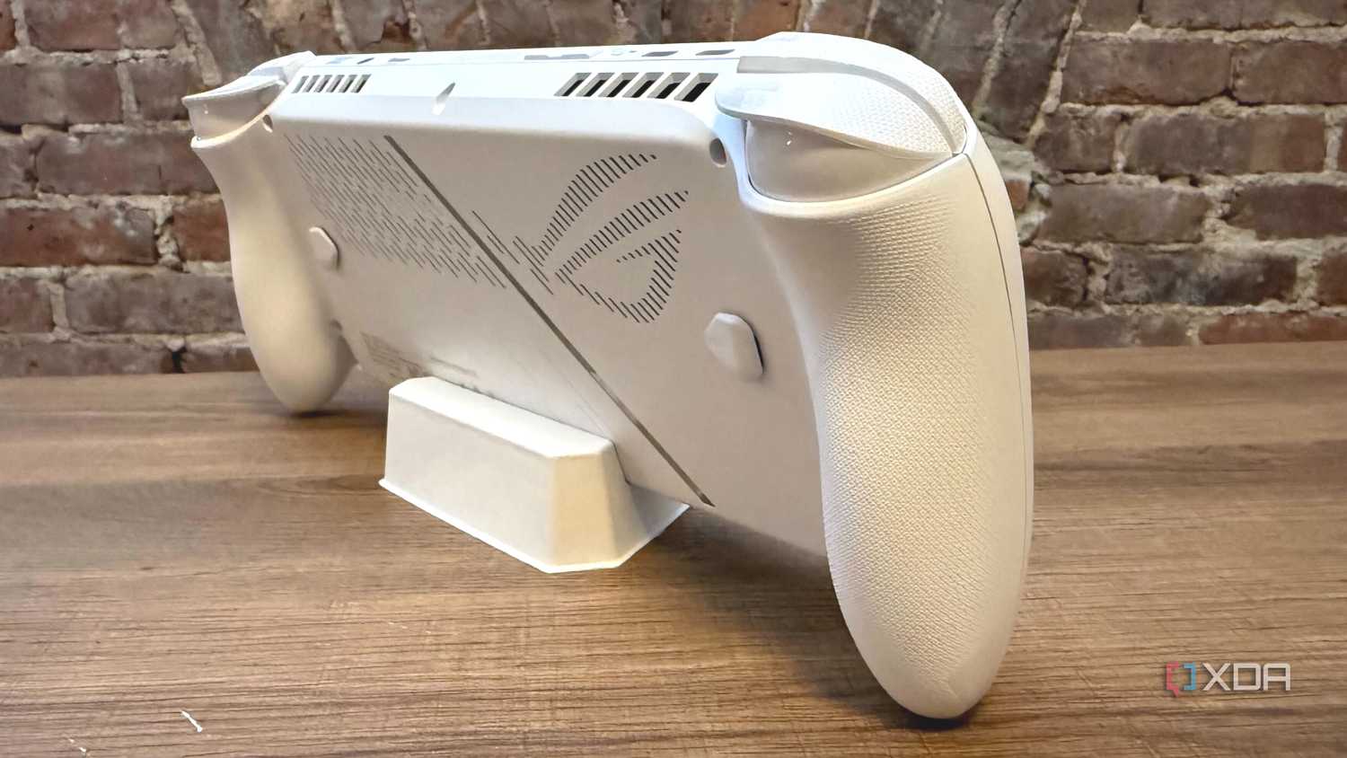 Angled view of the Asus ROG Ally, focusing on the ROG detailing on the back side.