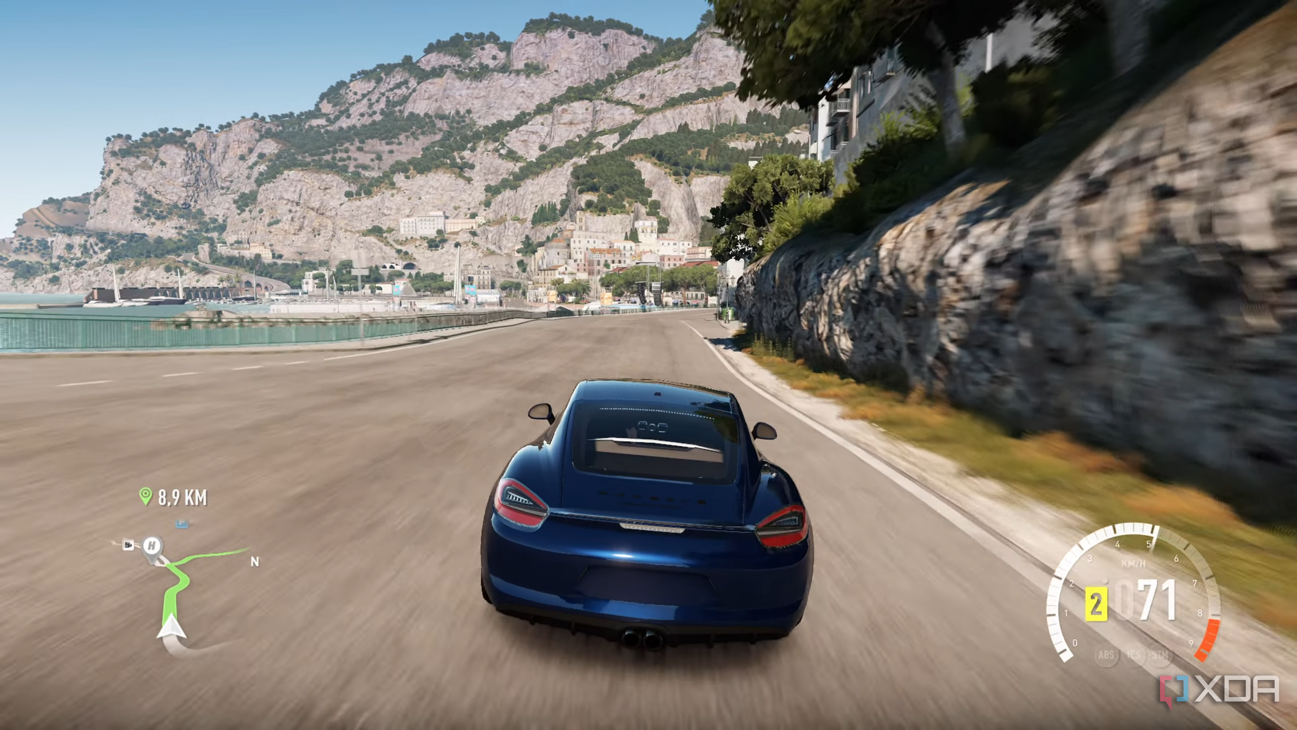 A blue Porsche racing down the Italian coast in Forza Horizon 2.