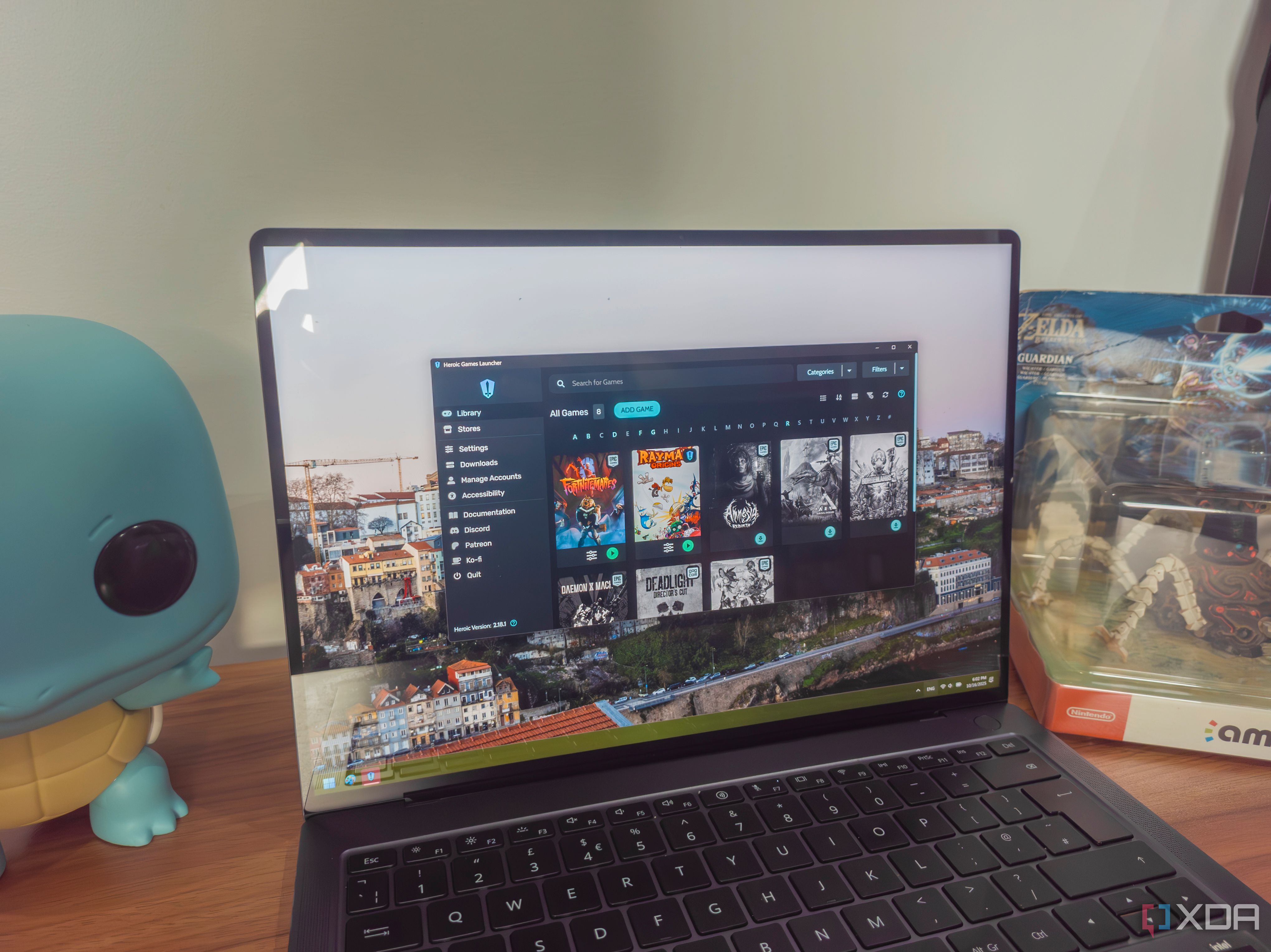 A Windows 11 laptop running Heroic Games Launcher and showing a library of games