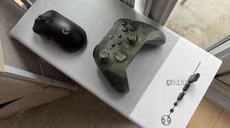 A mouse and controller on top of a PC chassis case