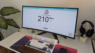 A PC setup showing a monitor with an internet speed test website
