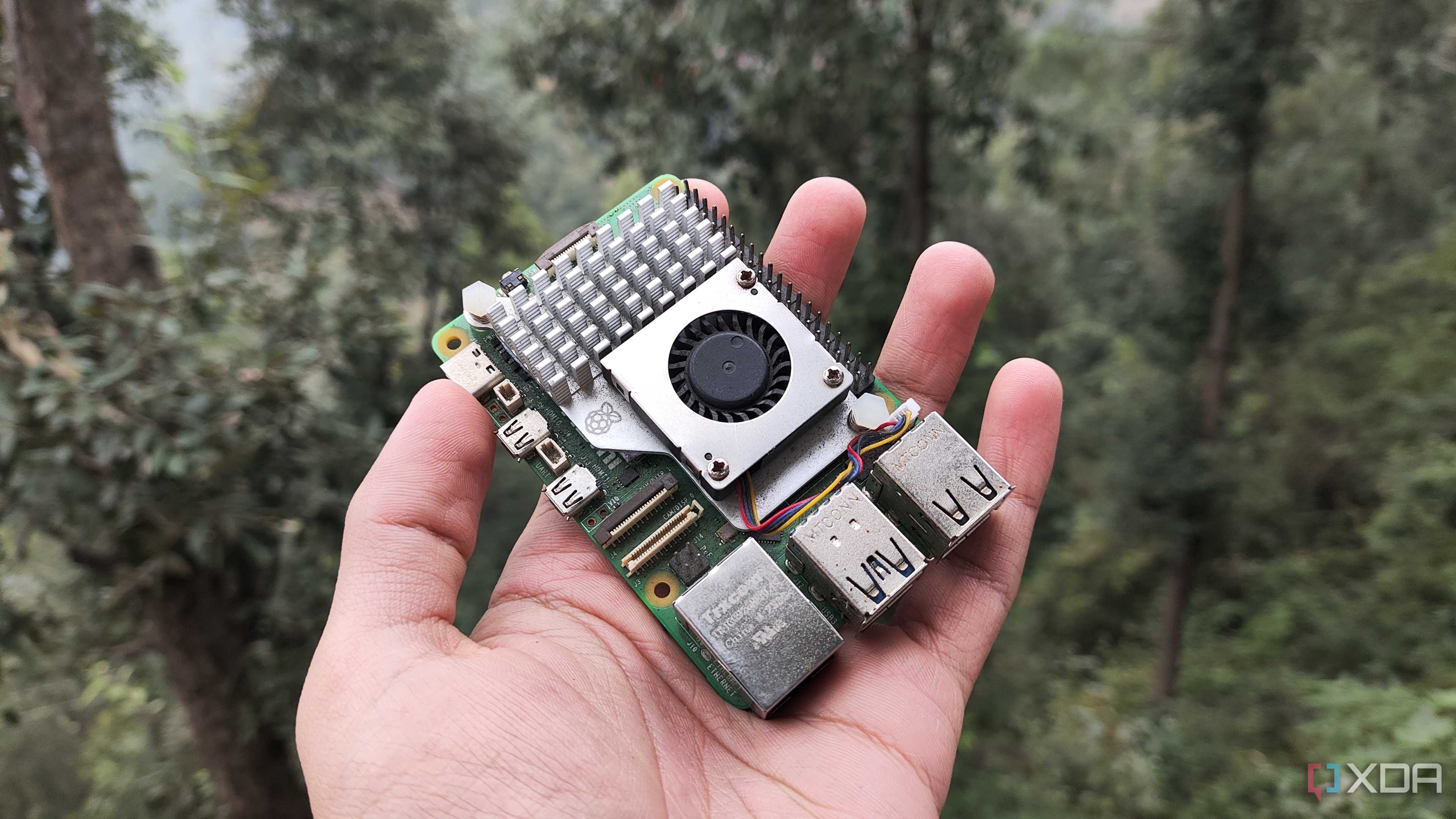 A person holding a Raspberry Pi 5