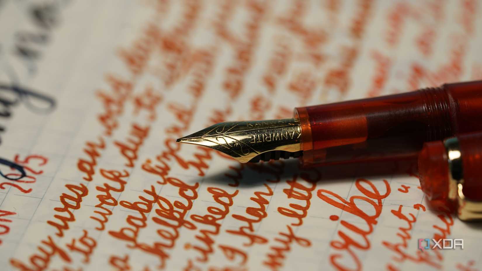 A red fountain pen on a page full of notes in orange ink