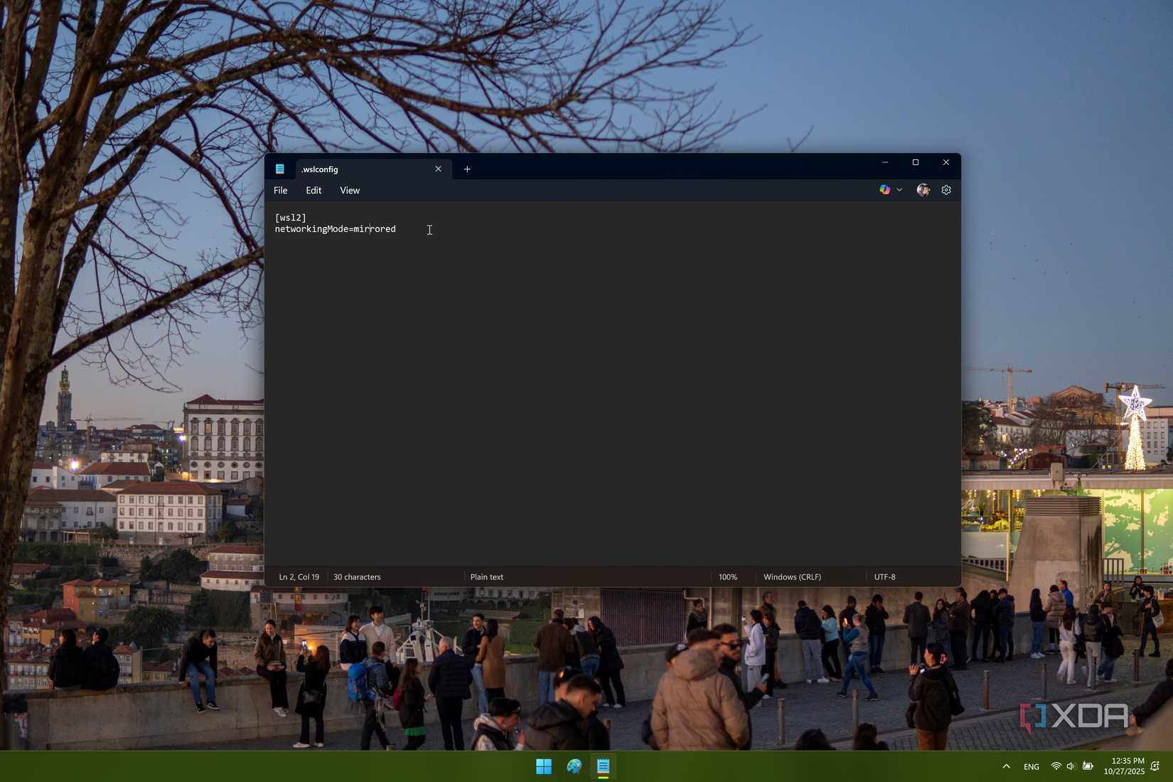 Screenshot of Windows Notepad showing the WSLconfig file with a setting to enable mirror mode networking