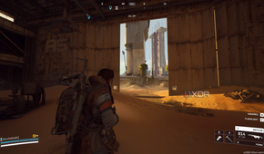 A vehicle maintenance facility overrun by sand in Arc Raiders' Spaceport map.